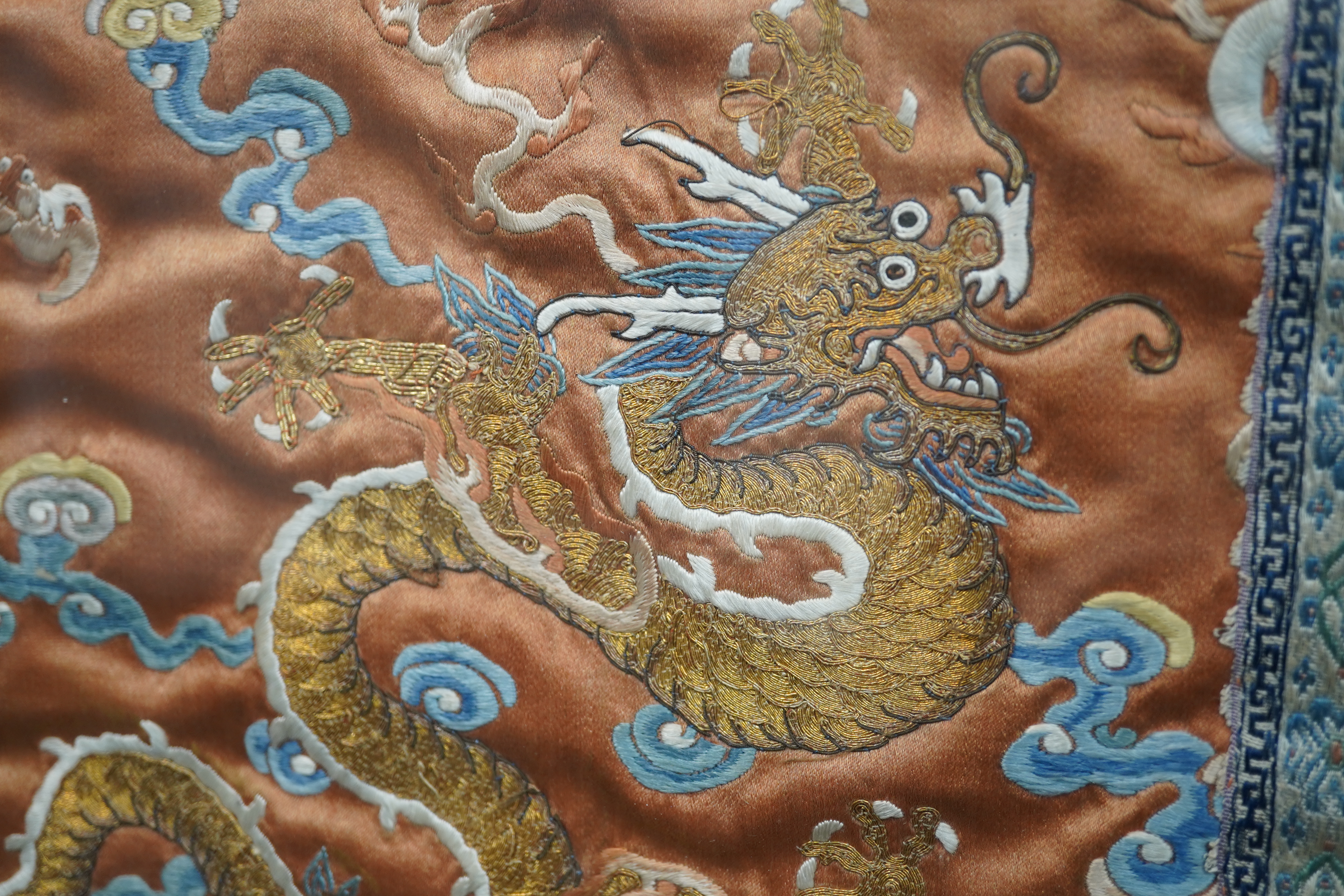 A pair of Chinese coral silk ‘dragon’ panels, 19th century